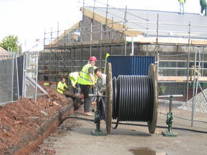 Fred Weston team laying cable on site